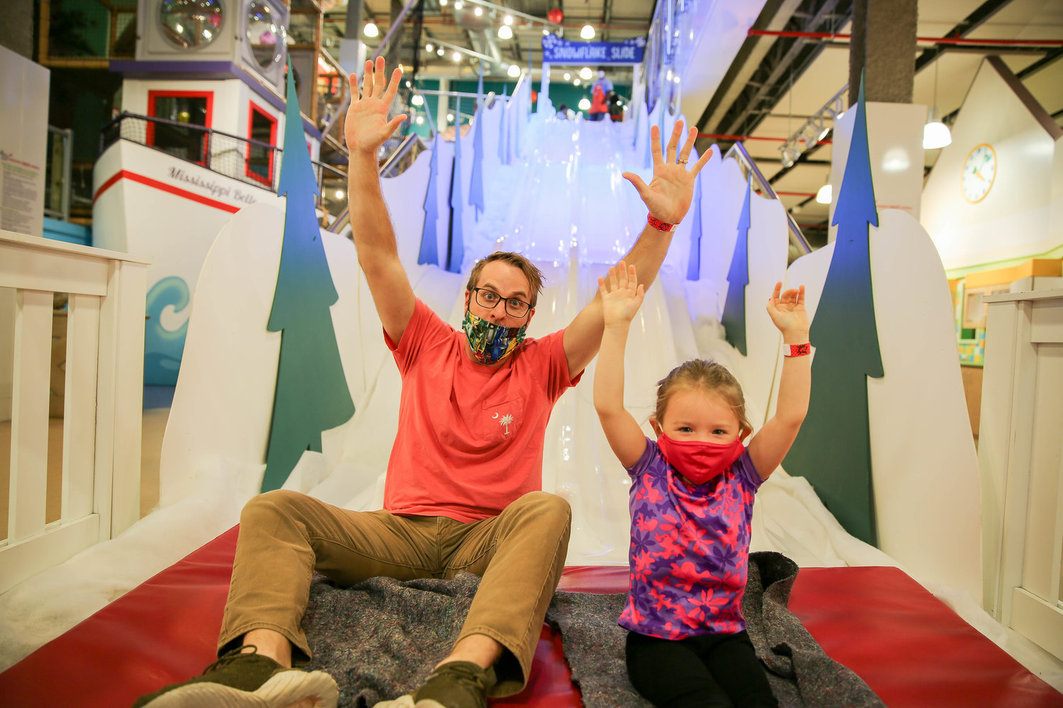 Carter Collins and Ruthie Collins finish their ride on the Snowflake Slide at the Mississippi Children’s Museum.
