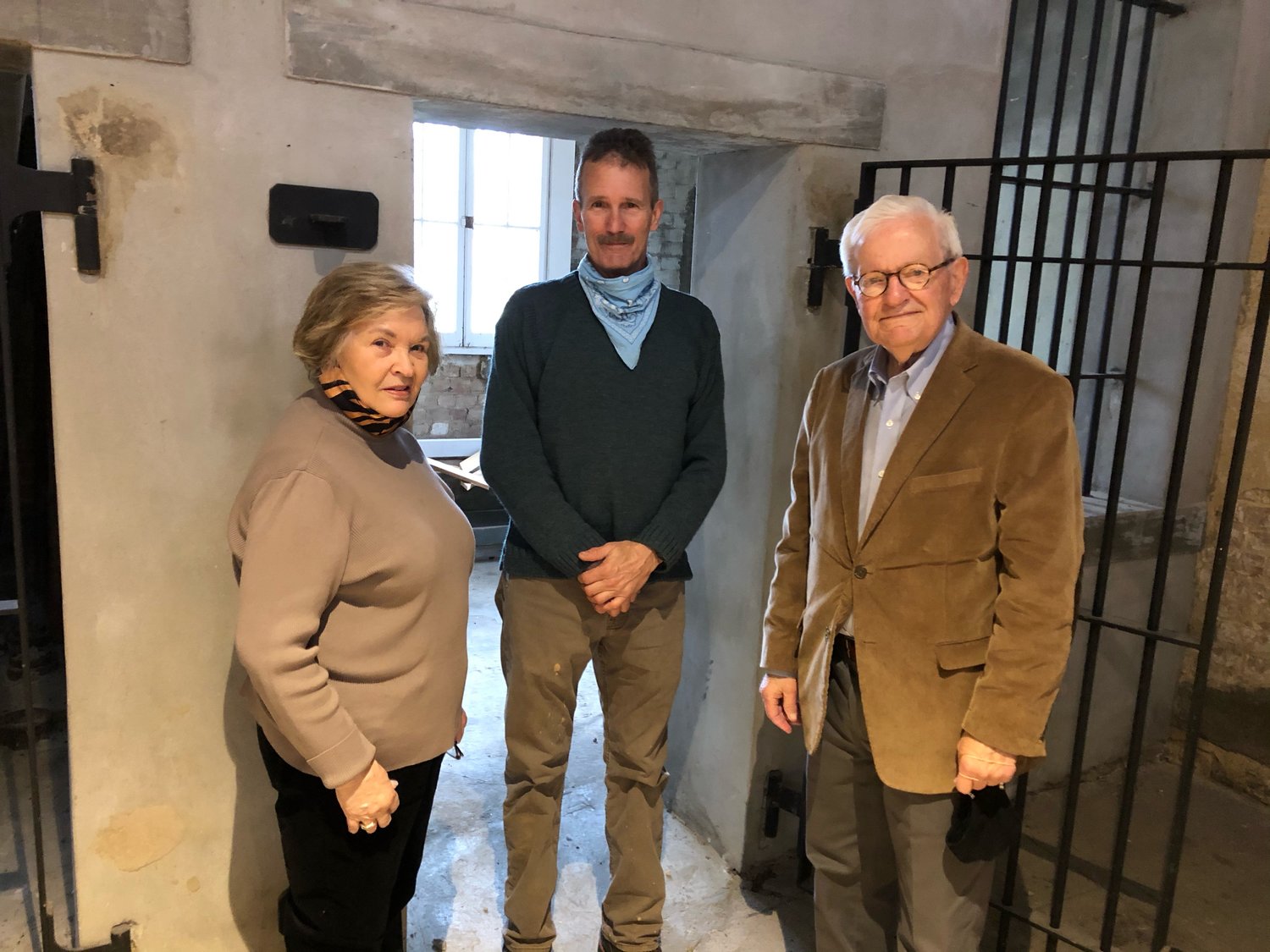 Canton-Madison County Historical Society members stand in front of one of the old jail cells in the 150-year-old Old Madison County Jail located in the heart of Canton. Pictured, from left: Maureen Simpson, Bill Dinkins, and Bob Montgomery.