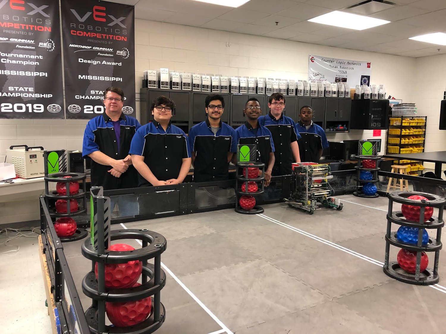 Pictured are winners of the 2021 VEX Robotics World Championship Build Award (l to r) Coach Bill Richardson, Mirage Giri, Shau Saini, Stephen Weathersby, Gabe Bordelon, and Ethan Young. Not Pictured are TJ Idris and Zakarie McDonald.