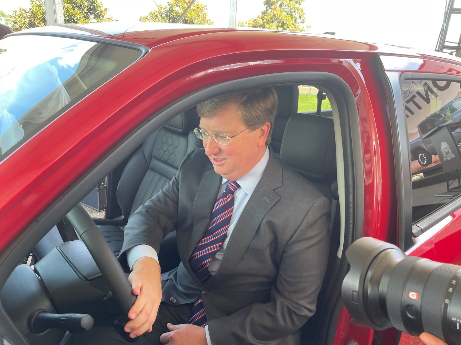 Gov. Tate Reeves sits behind the wheel of a brand new 2022 Nissan Frontier truck that was manufactured at the Canton plant. Automobile executives and business leaders announced the truck would be made exclusively in Madison County.