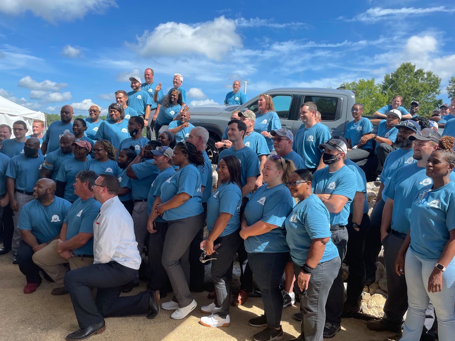 Nissan employees huddle together last week to celebrate the launch of the 2022 Frontier.