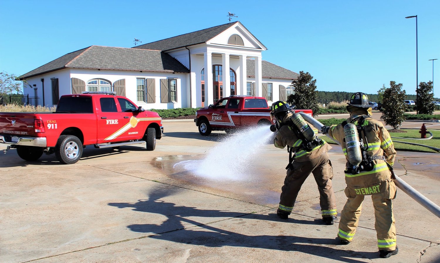 Madison firefighters Lt. Tommy Stewart and Cameron Willson training on team building, maneuvering and advancing a charged hose line during a training last month.