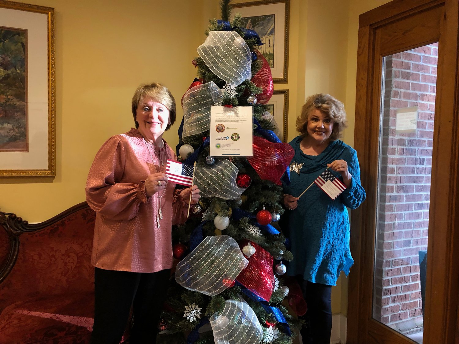 Madison Alderman Janie Jarvis and Mayor Mary Hawkins-Butler stand in front of the Hero Tree at City Hall, one of the three locations for the Hero Tree project in Madison County. The Hero Tree was inspired by the Angel Tree Project put on by the Salvation Army each year, and it helps out homeless veterans in need by providing them with personal care items.