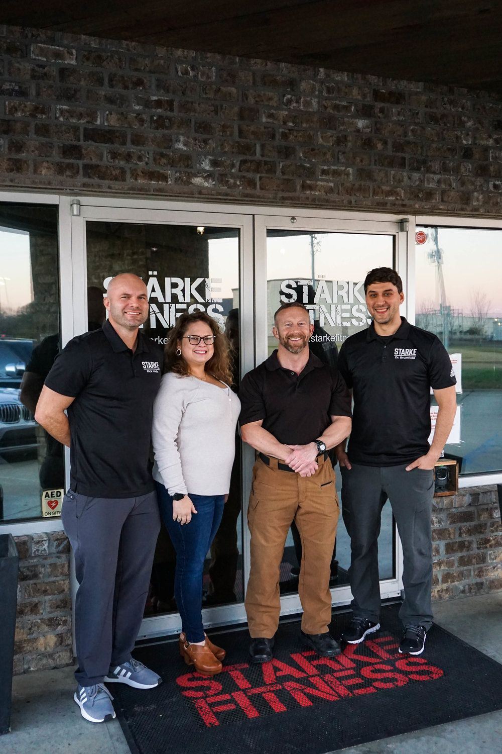 Owners and staff members of Starke Fitness and Wellness pose outside of the facility. Pictured, from left: Rick Wells, Meagan Wells, CEO and co-founder, Charlie Scoggins vice president of operations and corporate memberships, and Justin Brumfield, vice president of marketing and co-founder.