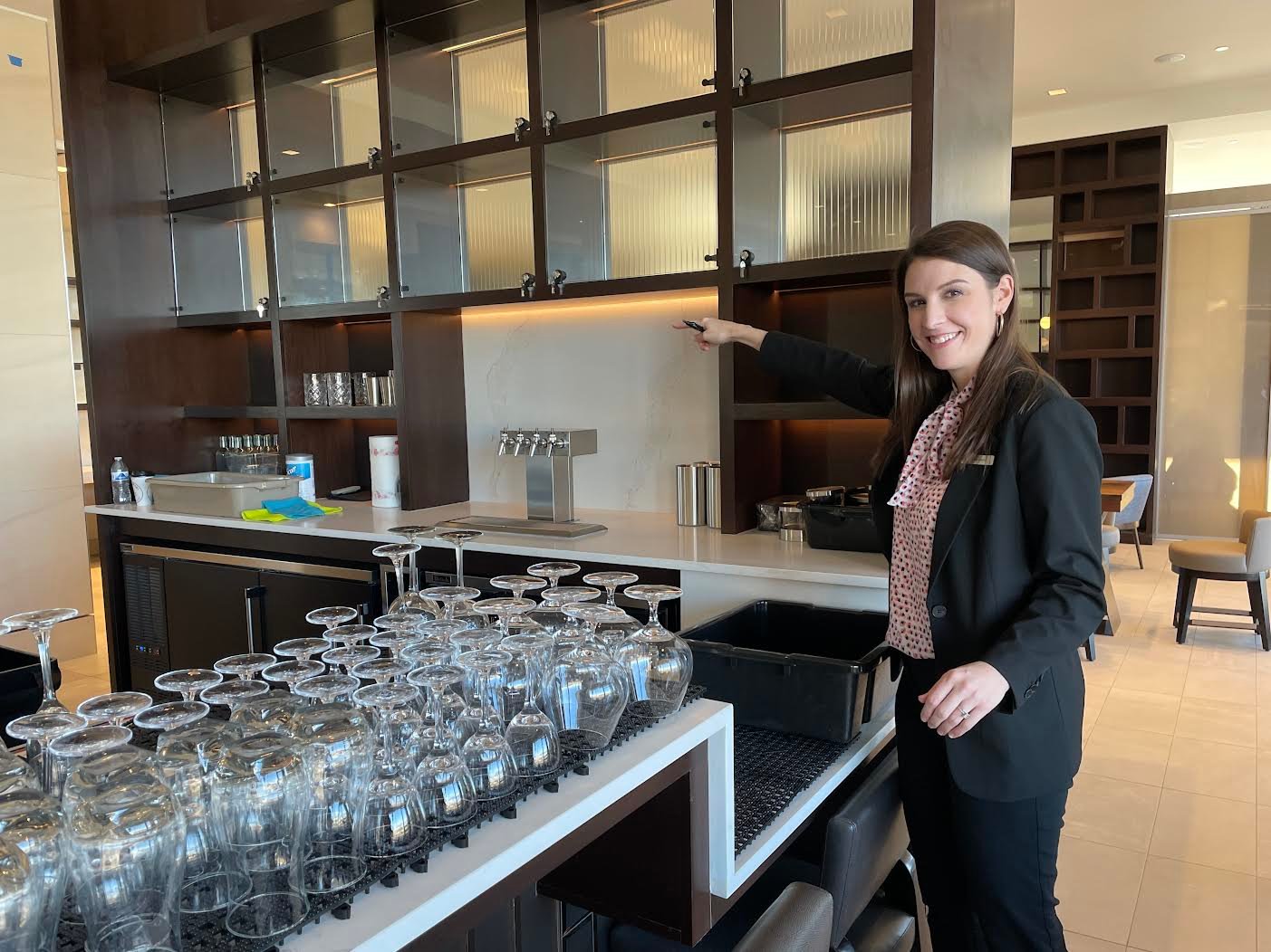 Amber Davis, director of sales, shows off the bar during a tour for local officials.