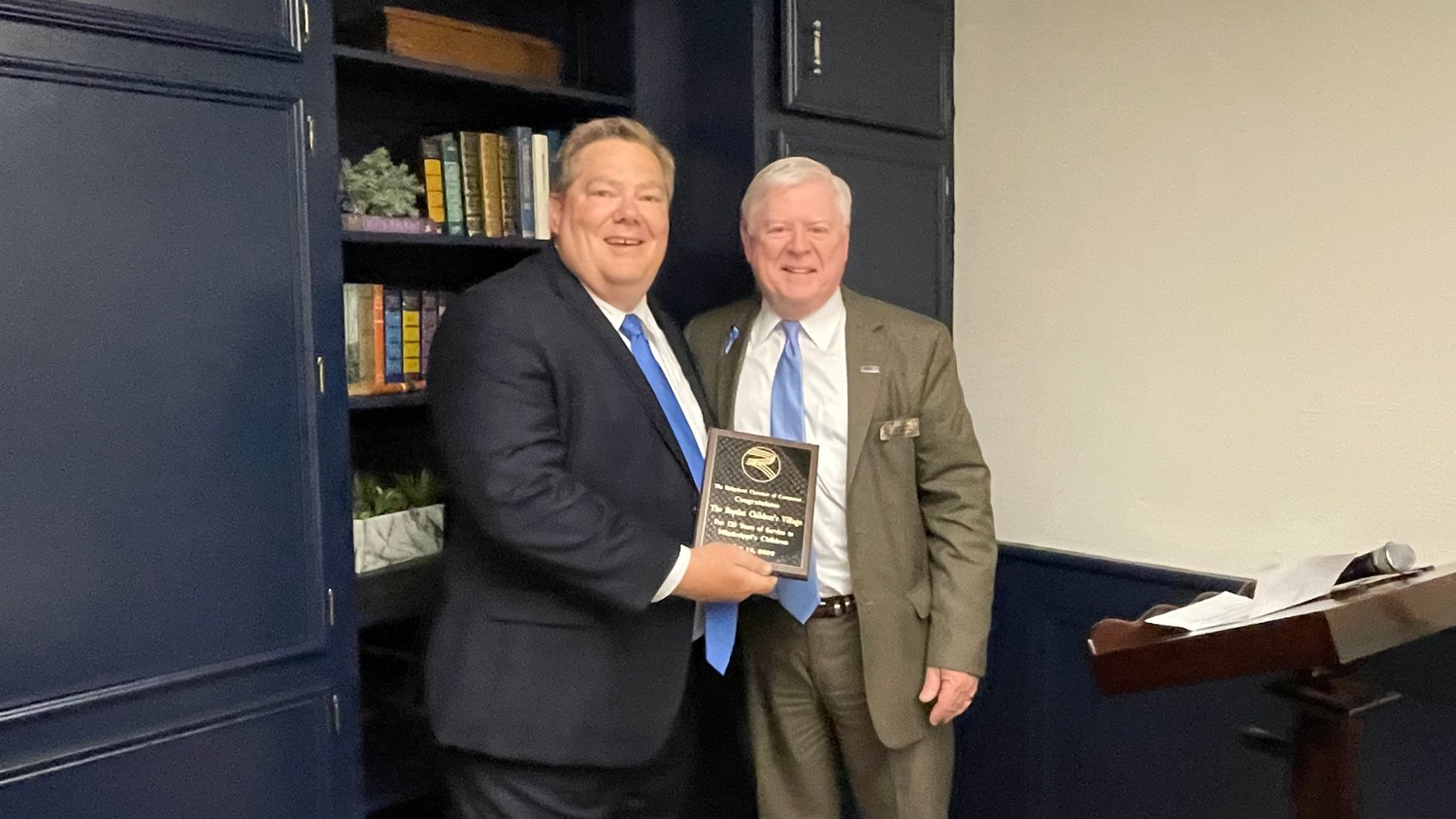 Baptist Children's Village Executive Director Sean Milner (left) stands with 
Ridgeland Chamber of Commerce Rep. Ray Balentine (right) after receiving a plaque honoring the 125th anniversary of the Baptist Children's Village. 