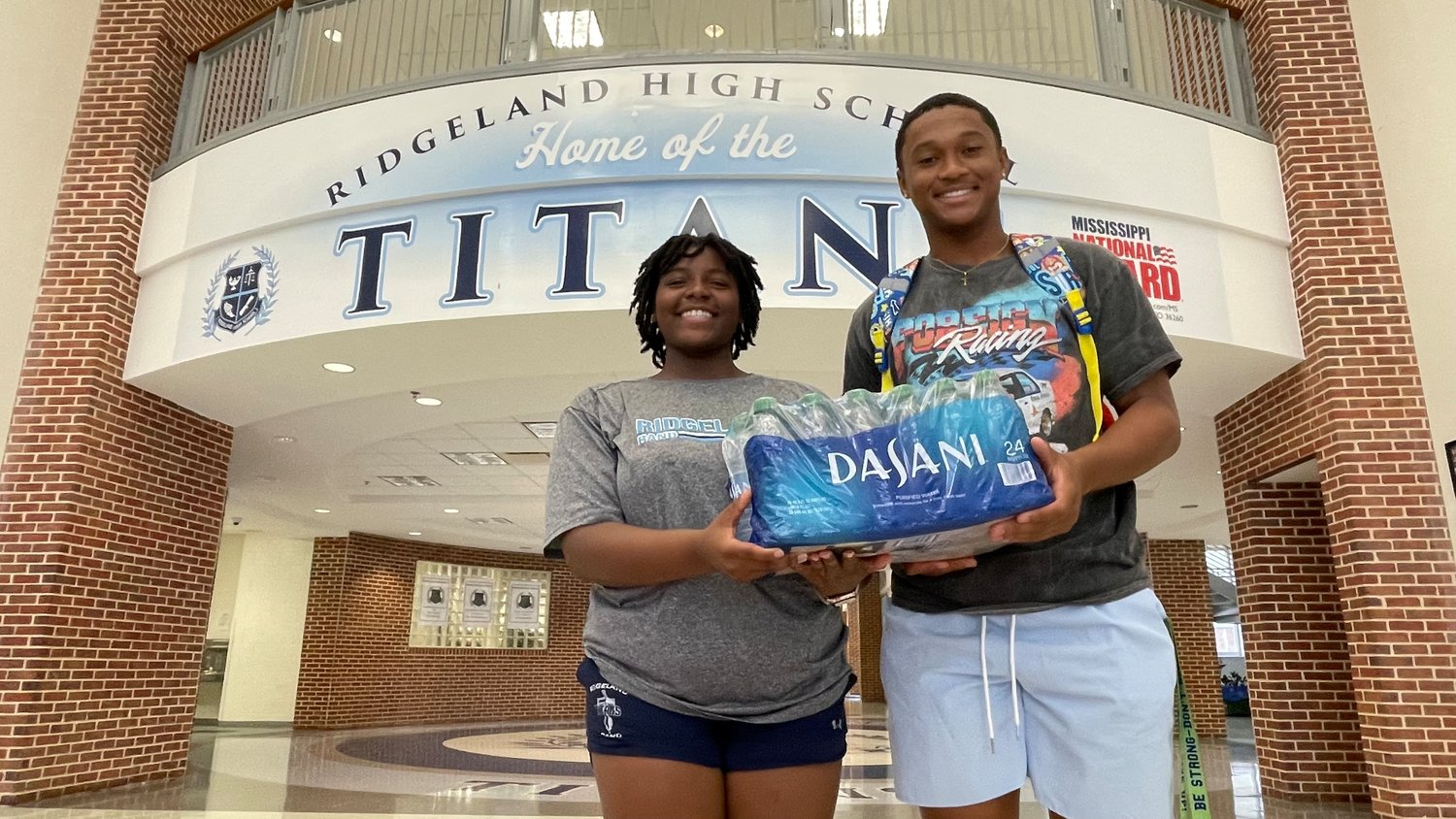 Ridgeland High School seniors James Woody and Deanna Ruffin pose with a case of water they plan to donate to Jackson Public Schools to help with the ongoing water crisis in the city of Jackson. Students from high schools across the county are participating.