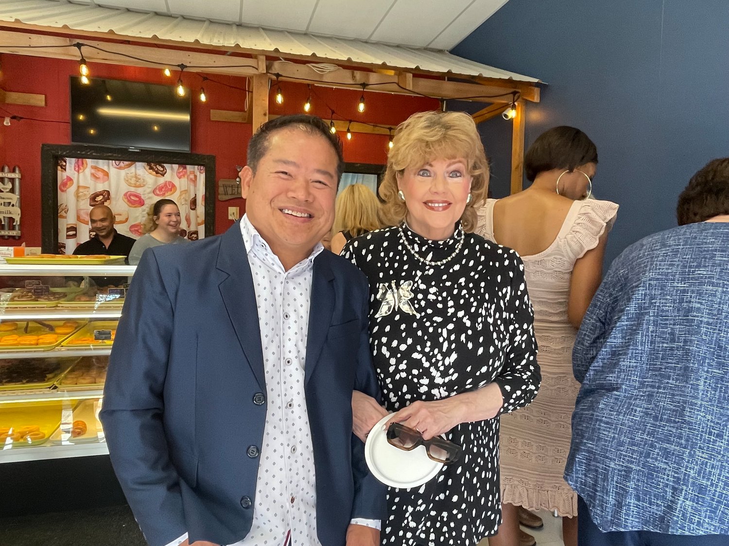 Donut Barn owner Frank Phann, left, with Madison Mayor Mary Hawkins-Butler after a grand re-opening of his business with a ribbon cutting last week.