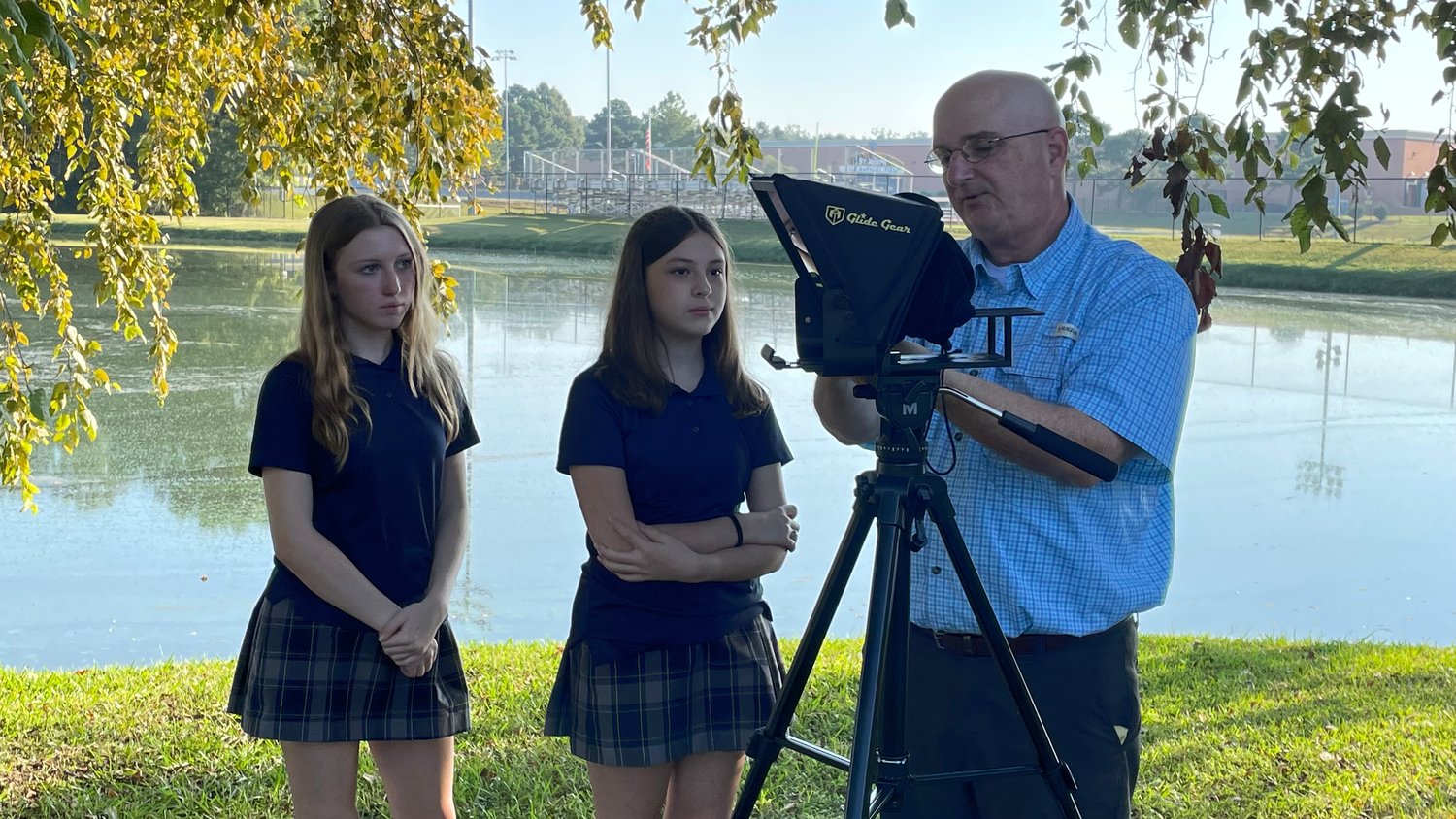 Terry Cassreino (right) shows eighth-graders Abby Stringer and Katie Venable the ropes on how to run a teleprompter.