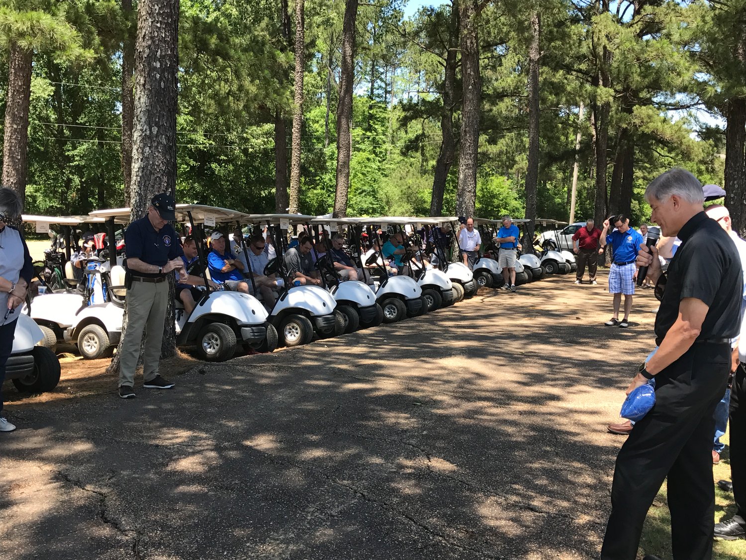 Golfers say a prayer before last year’s Doolittle Memorial Golf Classic.