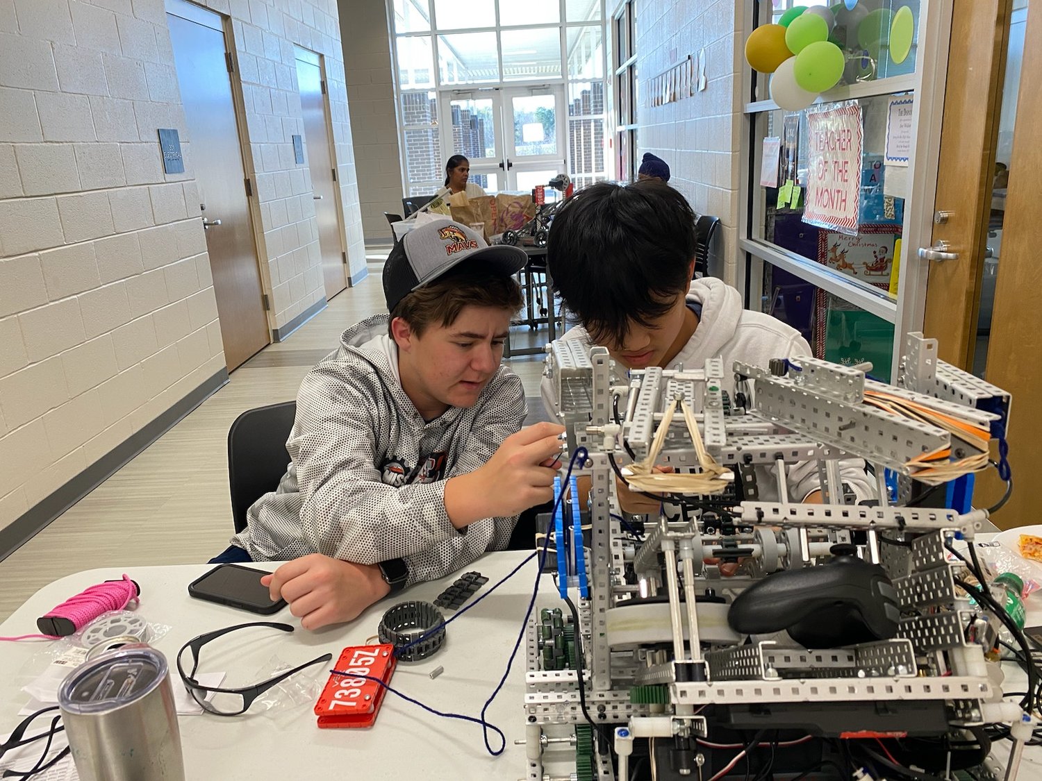 Walker Knight and Patrick Liu work on their robot.