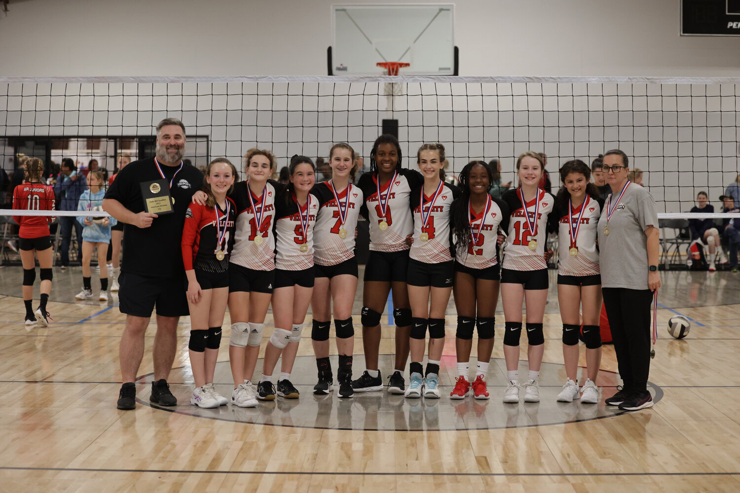 The MS Velocity Volleyball team gathers together after a game. Pictured, from left: Barrett Sharpe, Liza Whitt, Anabelle Sharpe, Catherine Bensler, Laura Catherine Freeman, Asia Lindsay, Gabi Strickland, Makenzie Taylor, Macy Gladden, Kylie Young, and Rita Sharpe.