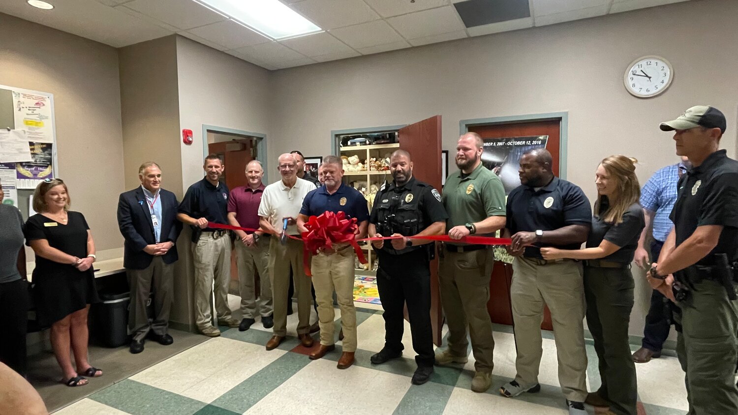 The City of Ridgeland cut the ribbon for the Ridgeland Police Department's new Canon's Closet, located in the RPD roll call room. Pictured, from left: Allison Deweese from Holmes Community College, John Dorsa from State Farm, Lt. Eddy Addison (Patrol Commander), Lt. Brett Bertucci (CID Commander), Mayor Gene McGee, Sgt. Ryan Jungers, Chief Brian Myers, Officer Scott Young, Officer Stephen Webb, Assistant Chief Stephen Webb,  Lt. Sara Perkins (Support Services Commander), and K9 Officer Ben Johnson.