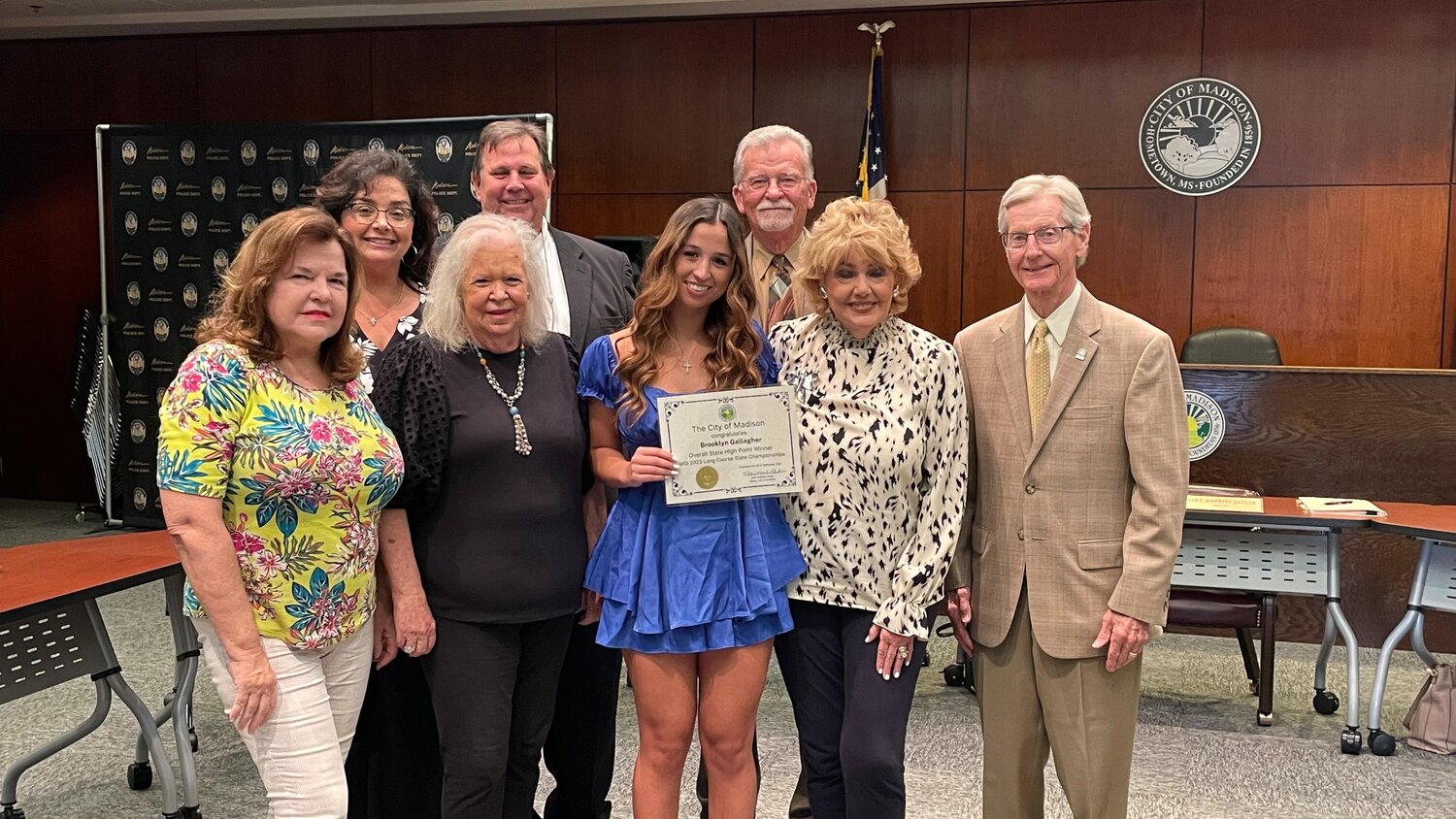 Madison’s Brooklyn Gallagher was recognized Tuesday night for her accomplishments during the 2023 Mississippi Swimming Long Course State Championship, where she took three first place wins for the Mississippi Makos. Mayor Mary Hawkins Butler recognized her accomplishments and presented Gallagher with a certificate. Pictured, from left: Alderwoman Pat Peeler, Alderman-at-Large Sandra Strain, Alderwoman Tawanna Tatum, Alderman Mike Hudgins, Brooklyn Gallagher, Alderman Paul Tankersley, Mayor Mary Hawkins-Butler, and Alderman Guy Bowering.
